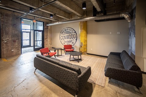 a room with couches chairs and a logo on the wall at Conwood Flats, Memphis, Tennessee